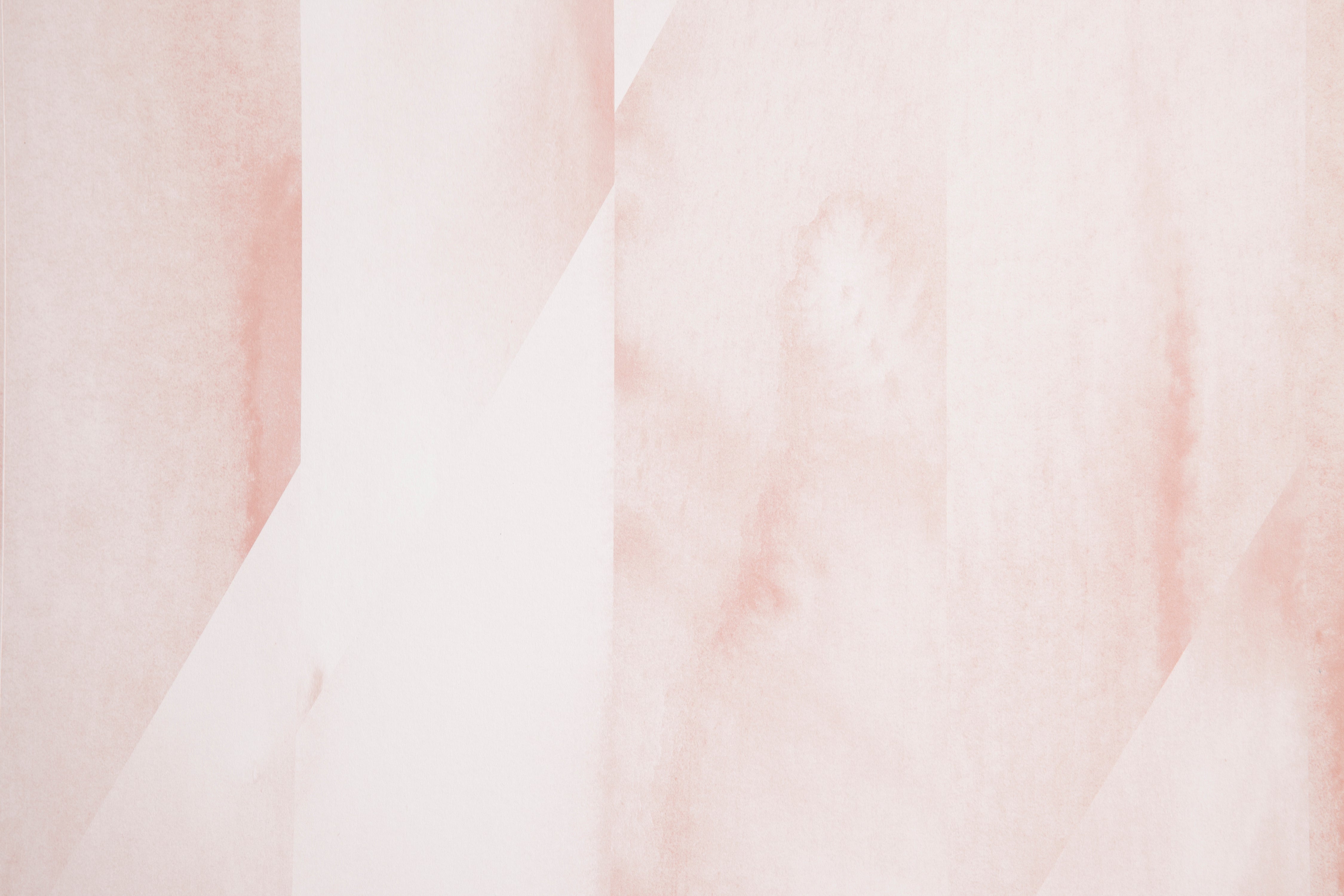 Detail of wallpaper in a linear geometric print in shades of pink and cream.