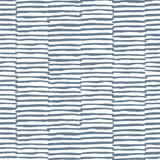 Detail of wallpaper in a broken stripe print in navy on a white field.