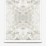 Partially unrolled wallpaper yardage in a watercolor textural print in shades of cream, gray and tan.