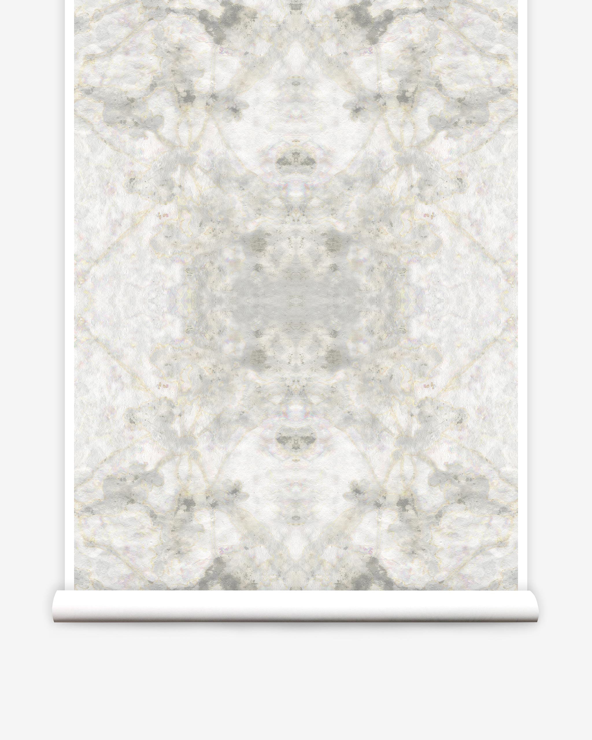 Partially unrolled wallpaper yardage in a watercolor textural print in shades of cream, gray and tan.