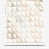 Partially unrolled wallpaper yardage in a painterly check pattern in shades of cream, tan and white.