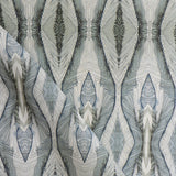 Draped fabric yardage in a watercolor diamond print in shades of gray and navy on a cream field.