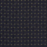 Detail of an embroidered fabric in a dashed basketweave design in navy blue with green accents.