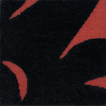 Detail of a handknotted rug with a raised sun motif in black on a red field.