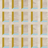 A potted cactus stands in front of a wall papered in a dimensional grid print in shades of cream, light blue and yellow.