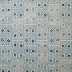 Wallpaper in a repeating damask print in navy and cream on a light blue field.
