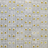 Wallpaper in a repeating damask print in mustard and white on a gray field.