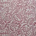 Wallpaper in a botanical paisley print in white on a dusty rose field.