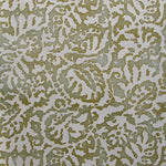 Wallpaper in a botanical paisley print in cream on a mottled tan field.