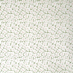 Wallpaper in a minimal floral print in red and green on a cream field.