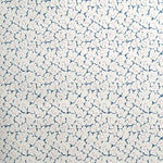 Wallpaper in a minimal floral print in pink and navy on a cream field.