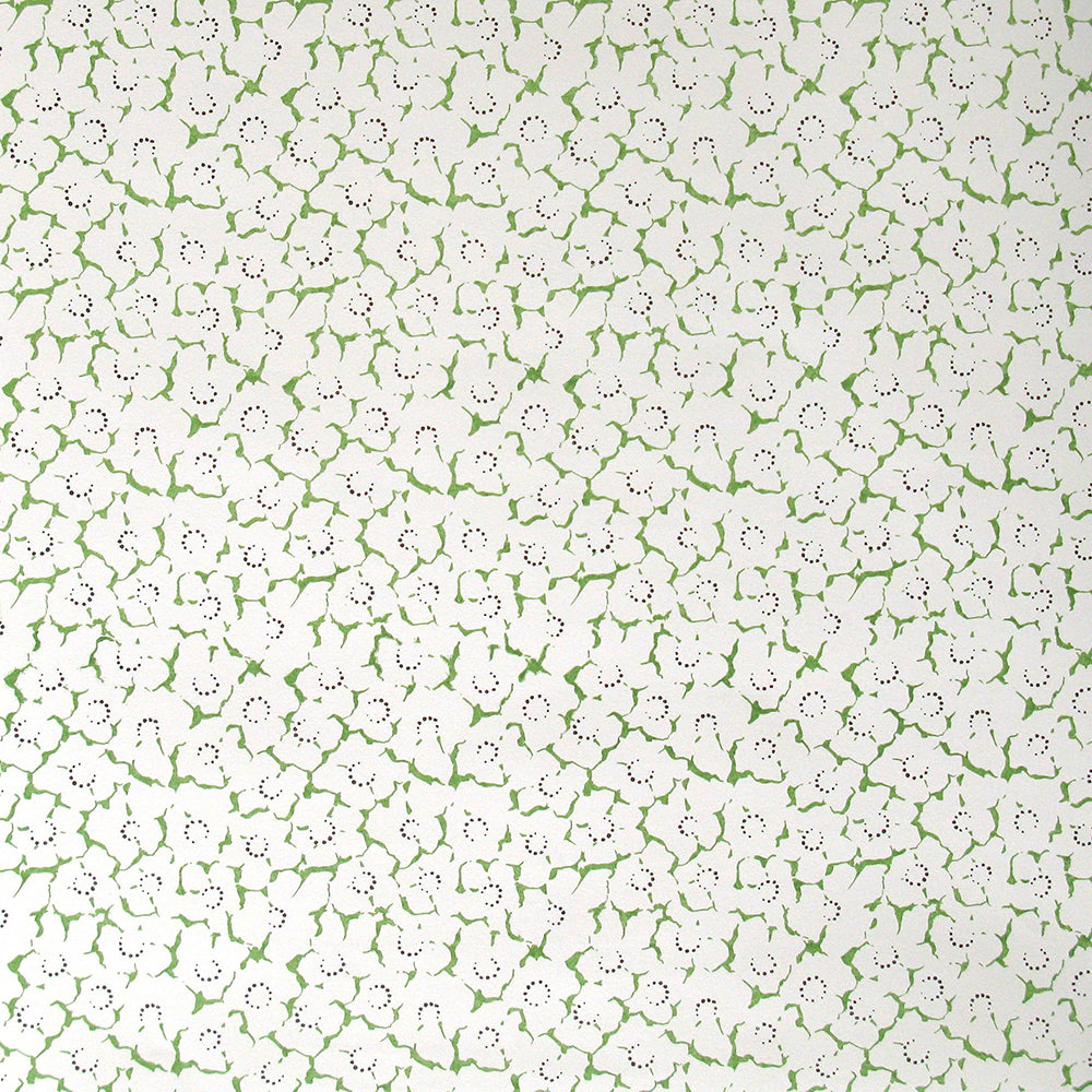 Wallpaper in a minimal floral print in navy and green on a cream field.