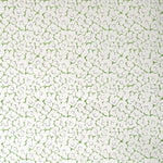 Wallpaper in a minimal floral print in navy and green on a cream field.