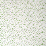 Wallpaper in a minimal floral print in navy and green on a cream field.