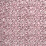 Detail of wallpaper in a dense paisley print in white on a dusty rose field.