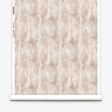 Wallpaper roll in a layered squiggle watercolor pattern in shades of pastel pink. 