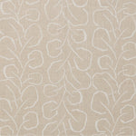 Woven fabric swatch with a large-scale repeating leaf print in white on a cream background.