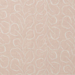 Woven fabric swatch with a large-scale repeating leaf print in white on a light pink background.