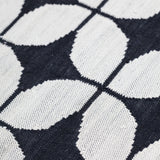 Alhambra Rug in black and white featuring a pattern of linked circles that create a star like lattice