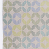 Detail of Alhambra Rug in Mint featuring a pattern of linked circles that create a star like lattice in a range of pastel turquoise, mint, yellow and lime green on a soft beige field. 