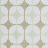 Detail of Alhambra Rug in Olive featuring pattern of linked circles that create a star like lattice in a soft olive and lime green on an ivory field. 