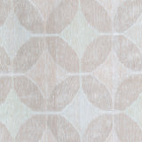 Detail of Alhambra Rug in Stonewash featuring pattern of linked circles that create a star like lattice in a range of pale pink tones a soft white field. 