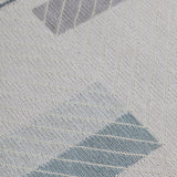 Detail of the Amelia Rug in Pearl featuring a minimalist broken stripe pattern, overlayed with thin white diagonal lines. The broken stripes are a mix of pale blues, grey, and turquoise with slate grey accents, all on a pale grey field. 