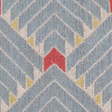 Detail of the Arrow Rug in Powder Blue-Coral features a dense pattern of nesting arrow shapes in soft blue with accents of coral and yellow on an ivory field. 