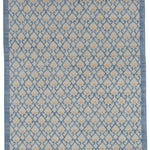 Full size Avesta Rug in Blue, a blue lattice pattern on a beige field with small orange heart accents. 