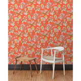 A chair and stool stand in front of a wall papered in large-scale line-drawn flowers in gray ink with red, pink and yellow watercolors, on a red background.