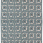 Full size Boe rug in Argento, featuring a pattern of white curved segments with taupe circles on a blue field. 