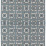 Full size Boe rug in Argento, featuring a pattern of white curved segments with taupe circles on a blue field. 