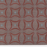 Detail of the Boe rug in Tivoli, featuring a pattern of crimsoncurved segments with light blue circles on a heather purple field. 