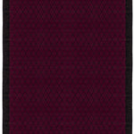 Full size Bucky Rug in berry, features a wide black border with a wine colored lattice field with a metallic sheen. 