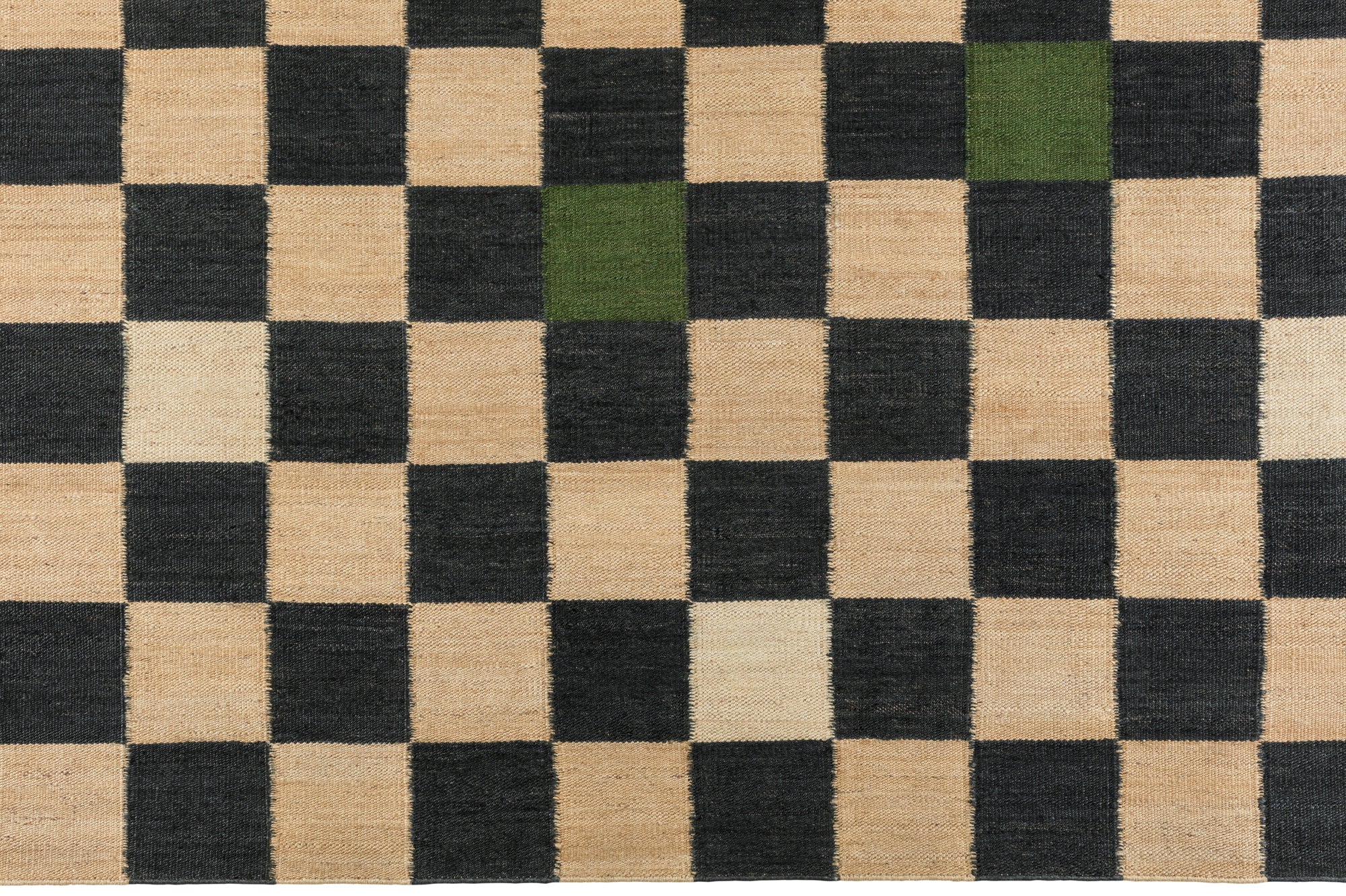 Detail of the Checkerboard Rug in King, a black and tan checkered pattern with random accents of green and white. 