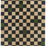 Detail of the Checkerboard Rug in King, a black and tan checkered pattern with random accents of green and white. 