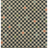 Detail of the Checkerboard Rug in King, a black and tan checkered pattern with random accents of green, sky blue and coral orange. 