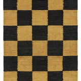 Detail of the Checkerboard Rug in Queen, a black and ochre yellow checkered pattern. 