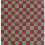 Detail of the Checkerboard Rug in Pawn, a red and sky blue checkered pattern. 