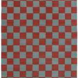 Detail of the Checkerboard Rug in Pawn, a red and sky blue checkered pattern. 