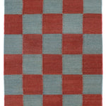 Detail of the Checkerboard Rug in Pawn, a red and osky blue checkered pattern. 