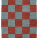 Detail of the Checkerboard Rug in Pawn, a red and osky blue checkered pattern. 