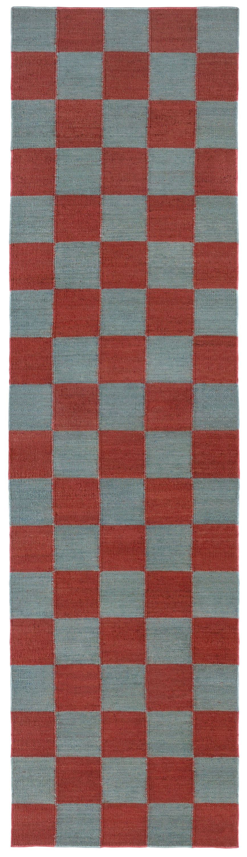 Detail of the Checkerboard Rug in Pawn, a red and osky blue checkered pattern. 