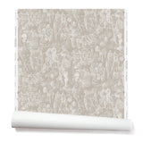 Partially unrolled wallpaper with a pattern of repeating watercolor illustrations of horses, farmers and country houses in white on a tan background.