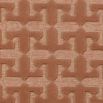 Detail of the Iseo Rug in Conch, a textural monochromatic abstract geometric pattern in terracotta coral color. 