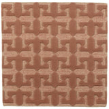 Detail of the Iseo Rug in Conch, a textural monochromatic abstract geometric pattern in terracotta coral color. 