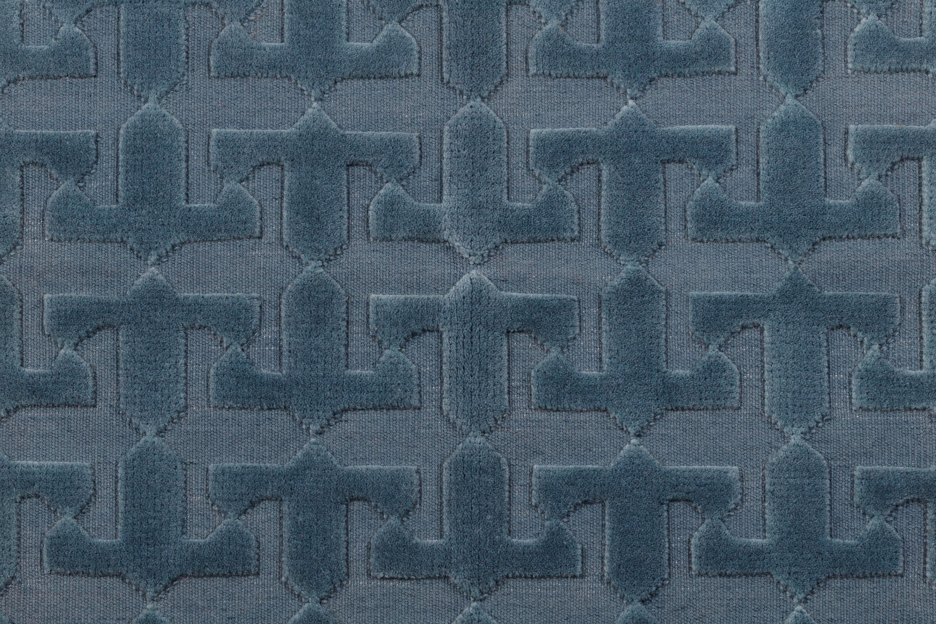 Detail of the Rug in Stormy Sky, a textural monochromatic abstract geometric pattern in blue. 