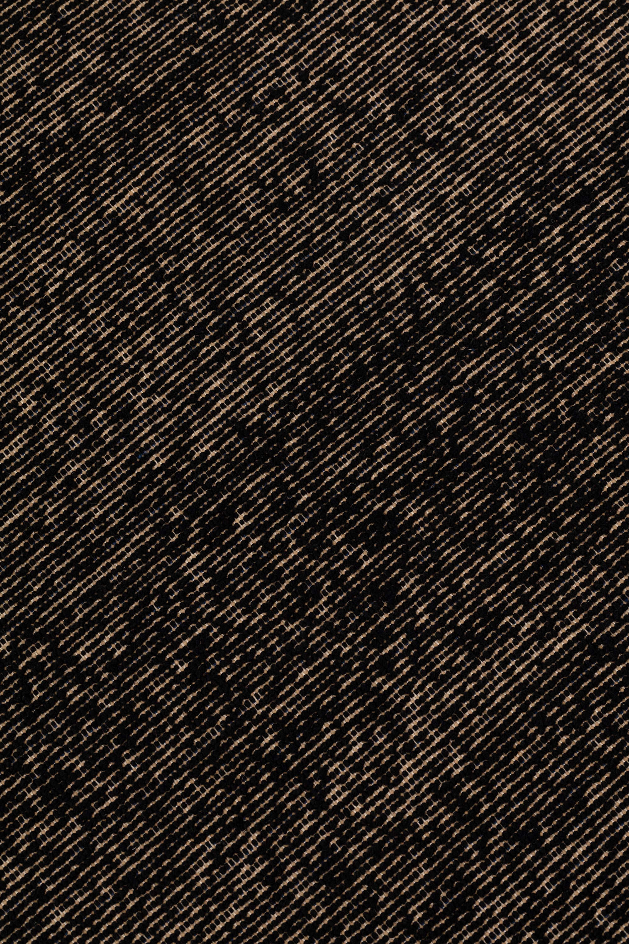 Detail of the Penta Rug in Night Fall, a subtle striated pattern in black and taupe. 