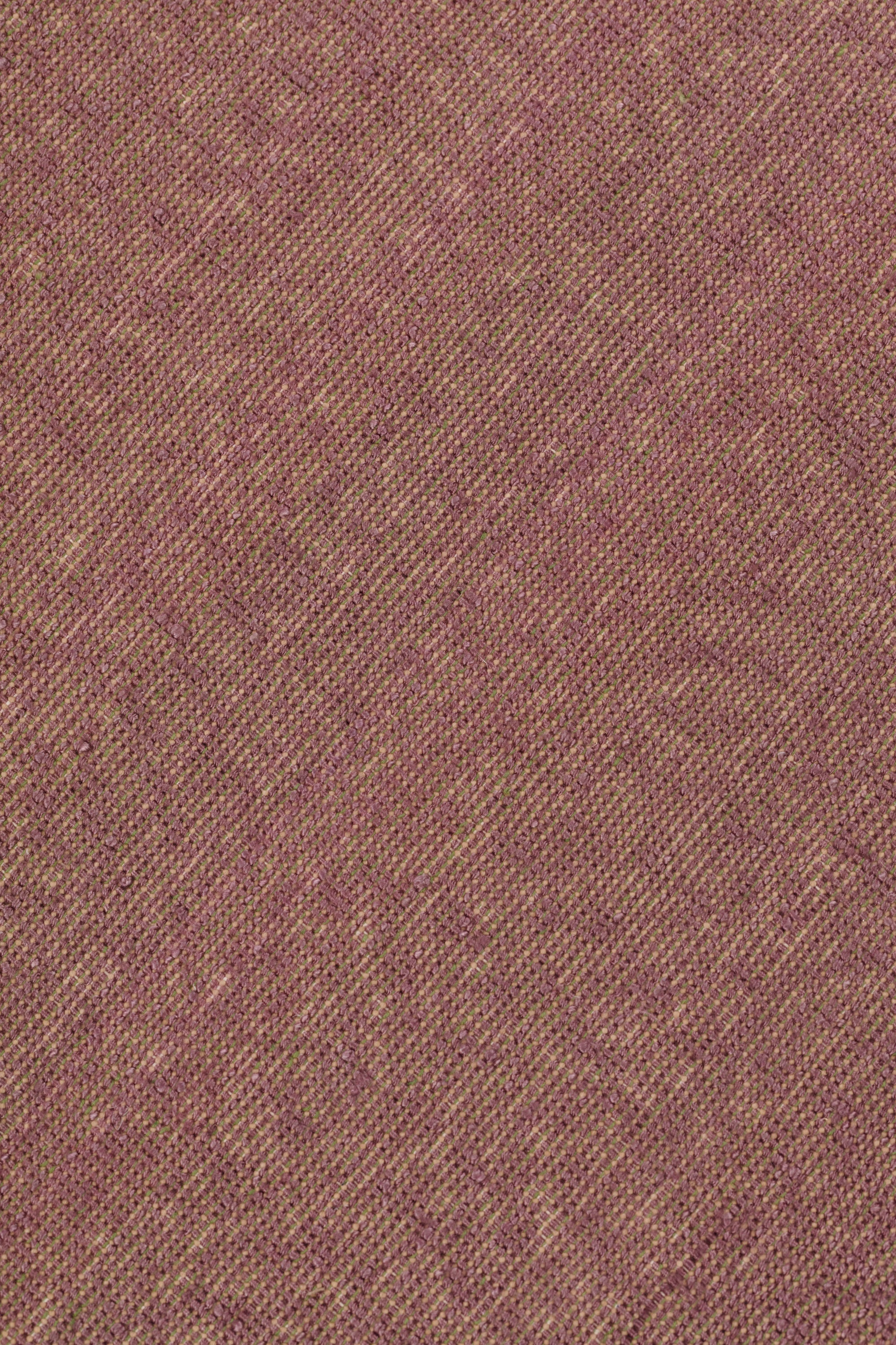 Detail of the Penta Rug in Sea Heather, a subtle striated pattern in warm purple and taupe. 