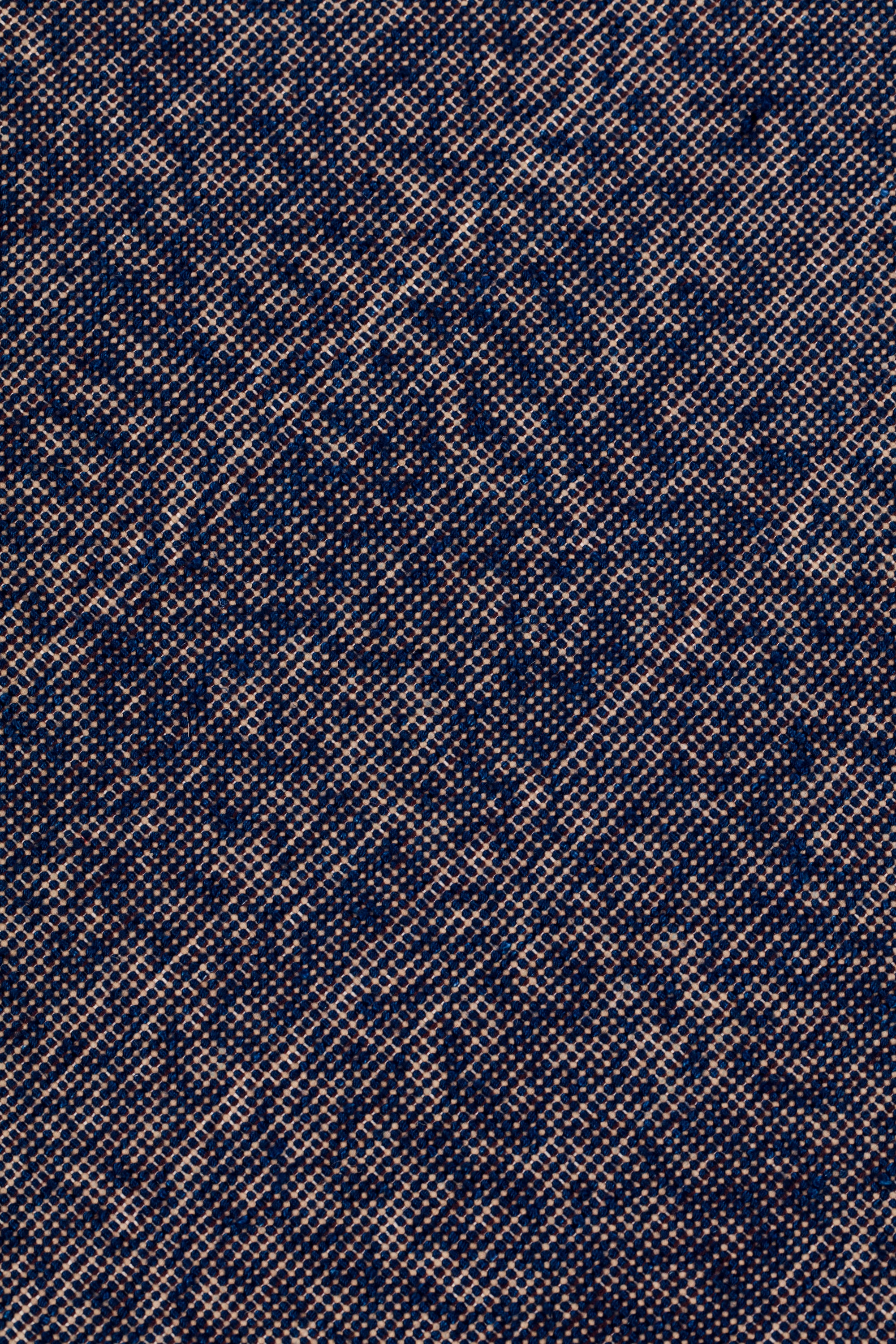 Detail of the Penta Rug in Tempestl, a subtle striated pattern in indigo blue and taupe. 